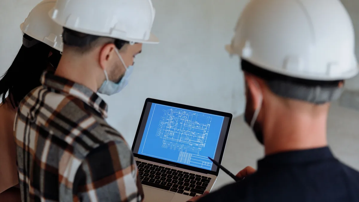Construction team reviewing a digital blueprint on site