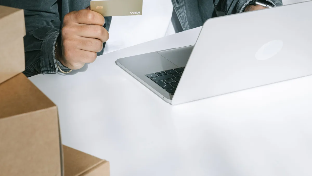 Online order workspace with a laptop and shipping boxes