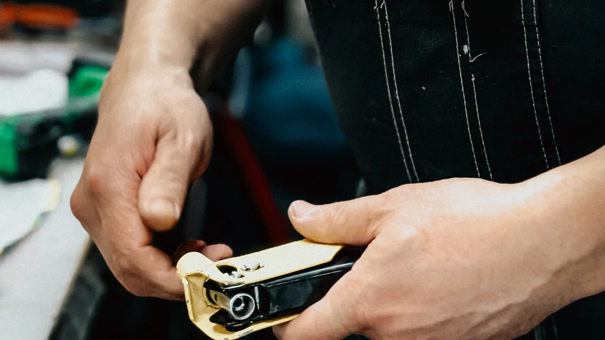 Tradesperson using a hand tool in a workshop